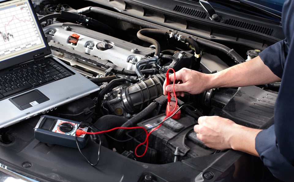 Ford technician servicing a vehicle battery