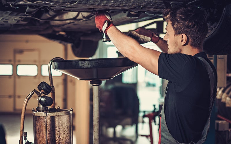 Ford technician performing an oil change